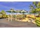 Fun playground shaded by canopies, set in a sandy area with nearby trees and a bench at 560 W Powell Way, Chandler, AZ 85248