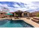 Poolside retreat with a fire pit, shaded outdoor seating area, and elegant stone detailing at 560 W Powell Way, Chandler, AZ 85248