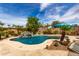 The backyard showcases a refreshing pool with rock waterfall feature and mature desert landscaping at 560 W Powell Way, Chandler, AZ 85248