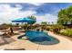 Backyard paradise featuring a pool with a rock waterfall and island under clear blue skies at 560 W Powell Way, Chandler, AZ 85248