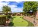 Backyard putting green with lush landscaping and manicured shrubbery at 560 W Powell Way, Chandler, AZ 85248
