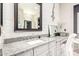 Bathroom featuring a granite countertop vanity, white cabinets, and a decorative mirror at 6112 E Calle De Pompas --, Cave Creek, AZ 85331