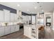 Elegant kitchen boasts stainless steel appliances, custom cabinets, an island, and barstool seating at 6112 E Calle De Pompas --, Cave Creek, AZ 85331