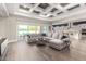 Spacious living room featuring hardwood floors, a coffered ceiling, and access to the outdoor patio at 6112 E Calle De Pompas --, Cave Creek, AZ 85331