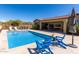 Inviting backyard pool with blue lounge chairs, built in bar and patio space perfect for entertaining at 6112 E Calle De Pompas --, Cave Creek, AZ 85331