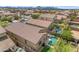 Expansive aerial view of homes with pools, desert landscaping, and tile roofs in a neighborhood setting against a mountain backdrop at 696 W Glen Canyon Dr, San Tan Valley, AZ 85140
