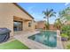 Private backyard featuring a pool, covered patio, desert landscaping, and an outdoor grill area at 696 W Glen Canyon Dr, San Tan Valley, AZ 85140