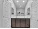 Bathroom with double sinks and a large mirror flanked by two doors at 696 W Glen Canyon Dr, San Tan Valley, AZ 85140