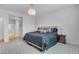 Bedroom with a large bed with black bedding and decorative chandelier at 696 W Glen Canyon Dr, San Tan Valley, AZ 85140