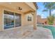 Covered patio with a ceiling fan, overlooking the pool with tile waterfall and desert landscaping at 696 W Glen Canyon Dr, San Tan Valley, AZ 85140