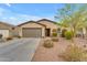 Single-story home featuring a desert landscaped front yard and a two car garage at 696 W Glen Canyon Dr, San Tan Valley, AZ 85140