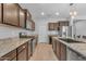Kitchen with stainless steel appliances, wood cabinets and granite countertops at 696 W Glen Canyon Dr, San Tan Valley, AZ 85140