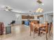 Open floor plan showcasing a spacious living room connected to a kitchen with a wooden dining set and stylish pendant lights at 696 W Glen Canyon Dr, San Tan Valley, AZ 85140