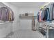 Spacious walk-in closet with ample hanging space, shelving, and a geometric patterned carpet at 696 W Glen Canyon Dr, San Tan Valley, AZ 85140