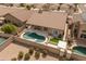 Aerial view of home's backyard pool, covered patio, artificial turf, landscaping, and block fence at 760 W Douglas Ave, Gilbert, AZ 85233
