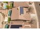 Aerial view of a house showing solar panels, pool, three car garage, desert landscaping, and neighboring houses at 760 W Douglas Ave, Gilbert, AZ 85233