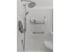 Bright bathroom featuring a tiled shower with a built-in seat and modern shower head at 760 W Douglas Ave, Gilbert, AZ 85233