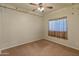 Neutral-toned bedroom with carpet, ceiling fan, window, and butterfly wall art at 760 W Douglas Ave, Gilbert, AZ 85233