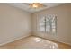 Bright bedroom featuring light-colored walls, wood-look flooring, and a leaf-style ceiling fan at 760 W Douglas Ave, Gilbert, AZ 85233