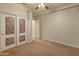 Bedroom features carpet flooring, ceiling fan, decorative wall art, and closet at 760 W Douglas Ave, Gilbert, AZ 85233