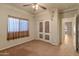 Bedroom featuring carpet flooring, ceiling fan, closet, and decorative wall art at 760 W Douglas Ave, Gilbert, AZ 85233