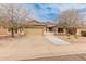 Charming single-story home boasts a tile roof, desert landscaping, and solar panels for energy efficiency at 760 W Douglas Ave, Gilbert, AZ 85233