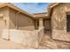 Inviting covered front porch features neutral stucco walls, a security door, and low maintenance landscape at 760 W Douglas Ave, Gilbert, AZ 85233