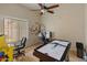 Fun game room with air hockey, arcade game, ceiling fan, and decorative wall art at 760 W Douglas Ave, Gilbert, AZ 85233