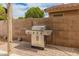 The stainless steel gas grill in the backyard has cabinets for storing grilling utensils at 760 W Douglas Ave, Gilbert, AZ 85233