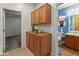 Hallway featuring wood-look floors and built-in cabinets, leading to a bedroom and bathroom at 760 W Douglas Ave, Gilbert, AZ 85233