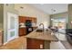 Open kitchen boasts granite countertops, stainless sink, and barstool seating at 760 W Douglas Ave, Gilbert, AZ 85233