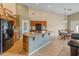 Kitchen island with breakfast bar seating and view of the dining area at 760 W Douglas Ave, Gilbert, AZ 85233