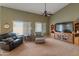 Inviting living room boasts high ceilings, a ceiling fan, and lots of natural light at 760 W Douglas Ave, Gilbert, AZ 85233