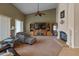 Bright living room featuring vaulted ceilings, a fireplace, and wood entertainment center at 760 W Douglas Ave, Gilbert, AZ 85233