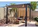 Outdoor area with a covered patio, cozy seating, and lush landscaping, creating a private outdoor space at 8014 W Ross Ave, Peoria, AZ 85382