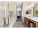 Bright bathroom featuring a soaking tub, walk-in shower, dual sinks and access to the main bedroom at 8014 W Ross Ave, Peoria, AZ 85382