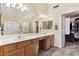 Bathroom featuring a large vanity with dual sinks, ample counter space, and walk in closet at 8014 W Ross Ave, Peoria, AZ 85382
