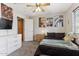 Cozy bedroom featuring neutral carpet, ceiling fan, dark furniture and a side view of the closet at 8014 W Ross Ave, Peoria, AZ 85382