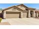 The home features a spacious three car garage and a large driveway at 8014 W Ross Ave, Peoria, AZ 85382