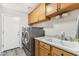 Efficient laundry room with modern washer/dryer, storage cabinets and sink at 8014 W Ross Ave, Peoria, AZ 85382