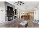 Open concept living room with fireplace and adjacent kitchen and dining areas at 8014 W Ross Ave, Peoria, AZ 85382