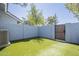 A private fenced-in backyard with artificial turf for easy maintenance at 860 N Mcqueen Rd # 1028, Chandler, AZ 85225