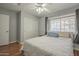 Well-lit bedroom with ceiling fan, closet, and a window with privacy blinds at 860 N Mcqueen Rd # 1028, Chandler, AZ 85225
