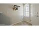 Bright entryway features tiled flooring, a convenient coat rack, and natural light from a window at 860 N Mcqueen Rd # 1028, Chandler, AZ 85225