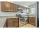 Kitchen features stainless steel appliances, granite countertops, and wood cabinets at 860 N Mcqueen Rd # 1028, Chandler, AZ 85225