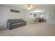 Cozy living room with soft carpeting, a ceiling fan, and an open layout to the dining area at 860 N Mcqueen Rd # 1028, Chandler, AZ 85225