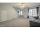 Spacious living room with neutral carpeting, a ceiling fan, and plenty of natural light at 860 N Mcqueen Rd # 1028, Chandler, AZ 85225