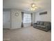 Comfortable living room with plush carpeting, a ceiling fan, and a view of the front entryway at 860 N Mcqueen Rd # 1028, Chandler, AZ 85225