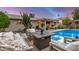 Cozy backyard featuring a fire pit area with comfortable seating next to the inviting pool at 8738 E Rose Ln, Scottsdale, AZ 85250
