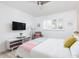 Bright bedroom boasts geometric accent wall, ceiling fan, and comfortable seating area at 8738 E Rose Ln, Scottsdale, AZ 85250